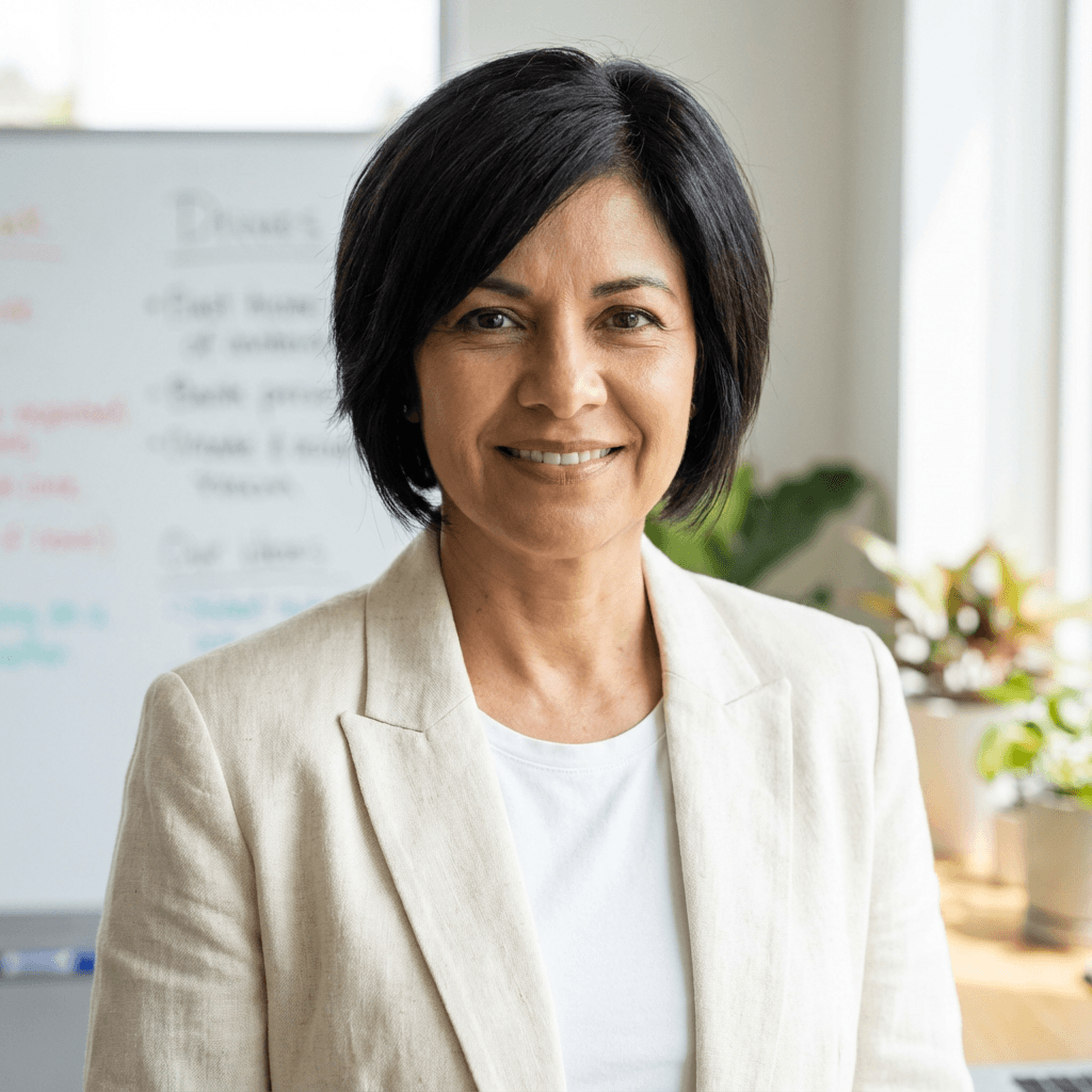Lena G. smiling in a casual office